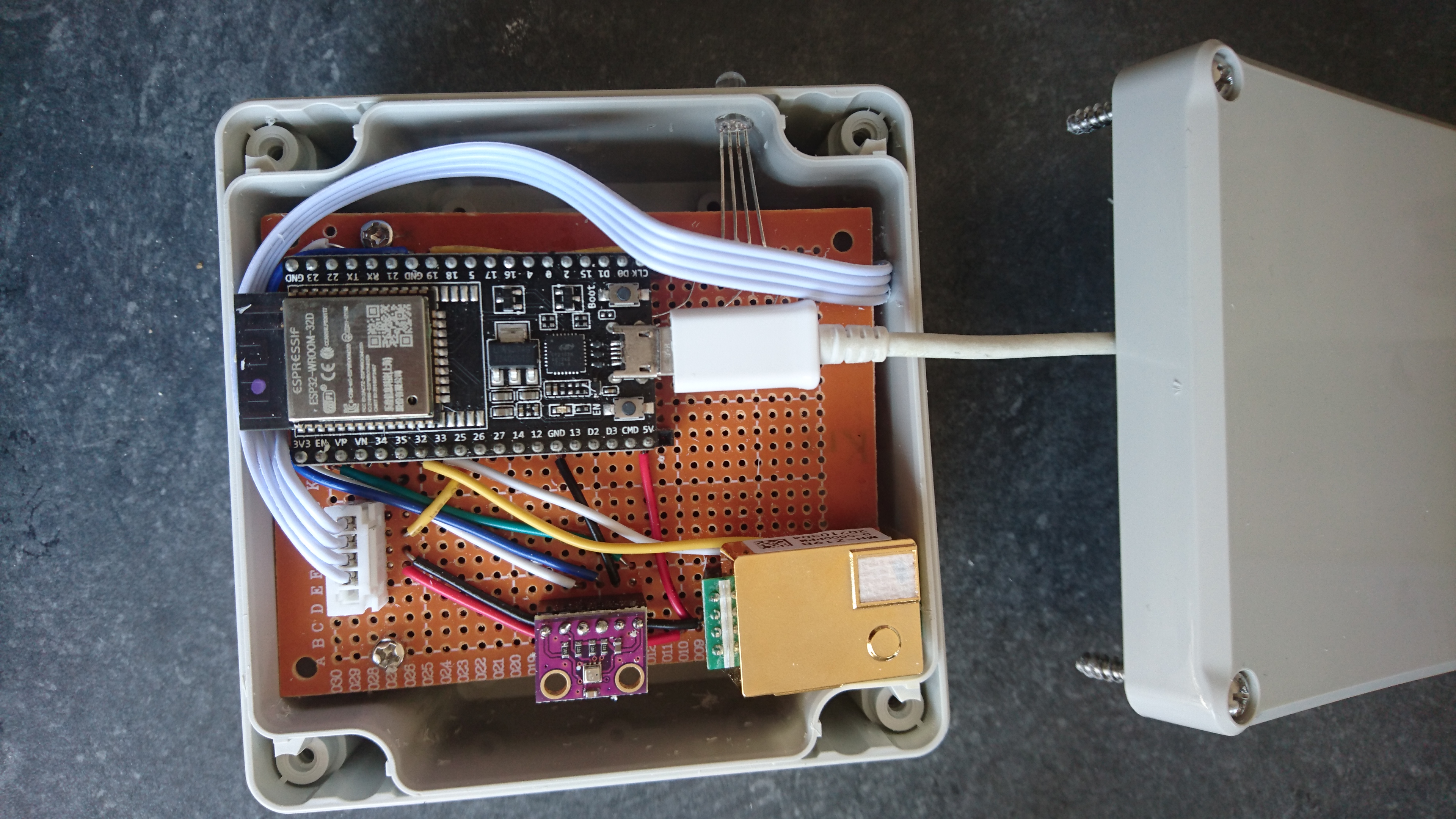 A DIY air quality monitor on a perfboard in a project box